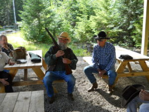 Jocko displays shotgun while Buckskin looks on.